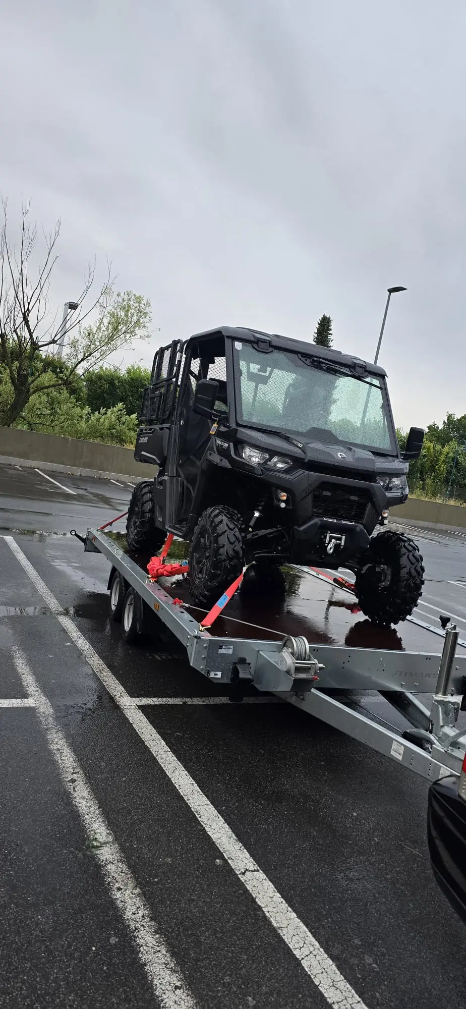 Autotransportanhänger auf nassem Parkplatz Mochi's Rental Perchtoldsdor